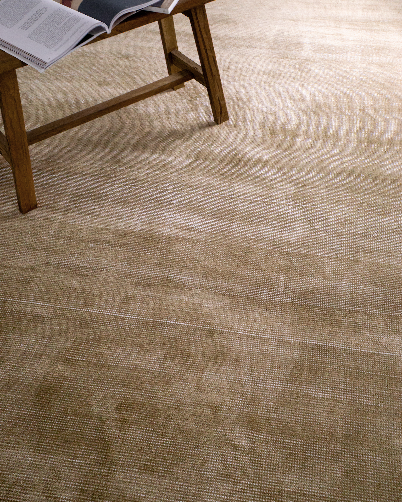 Beige textured rug with subtle horizontal striations and soft woven finish