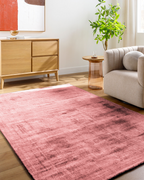 Modern distressed pink area rug with textured abstract pattern