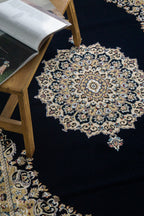 Black and gold traditional Persian style rug with ornate medallion pattern