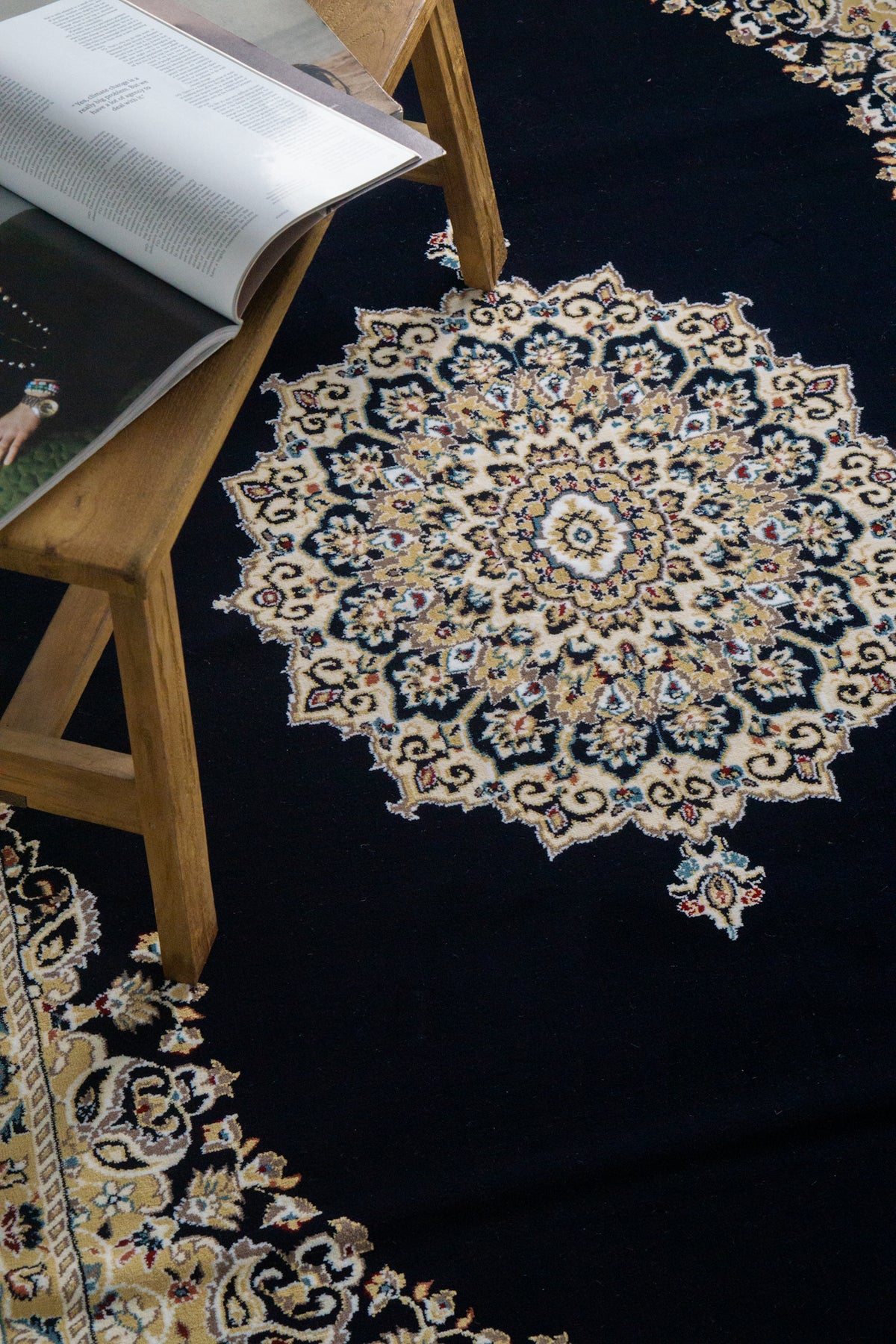 Black and gold traditional Persian style rug with ornate medallion pattern