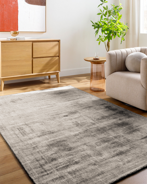 Modern distressed gray area rug with abstract textured pattern and neutral tone