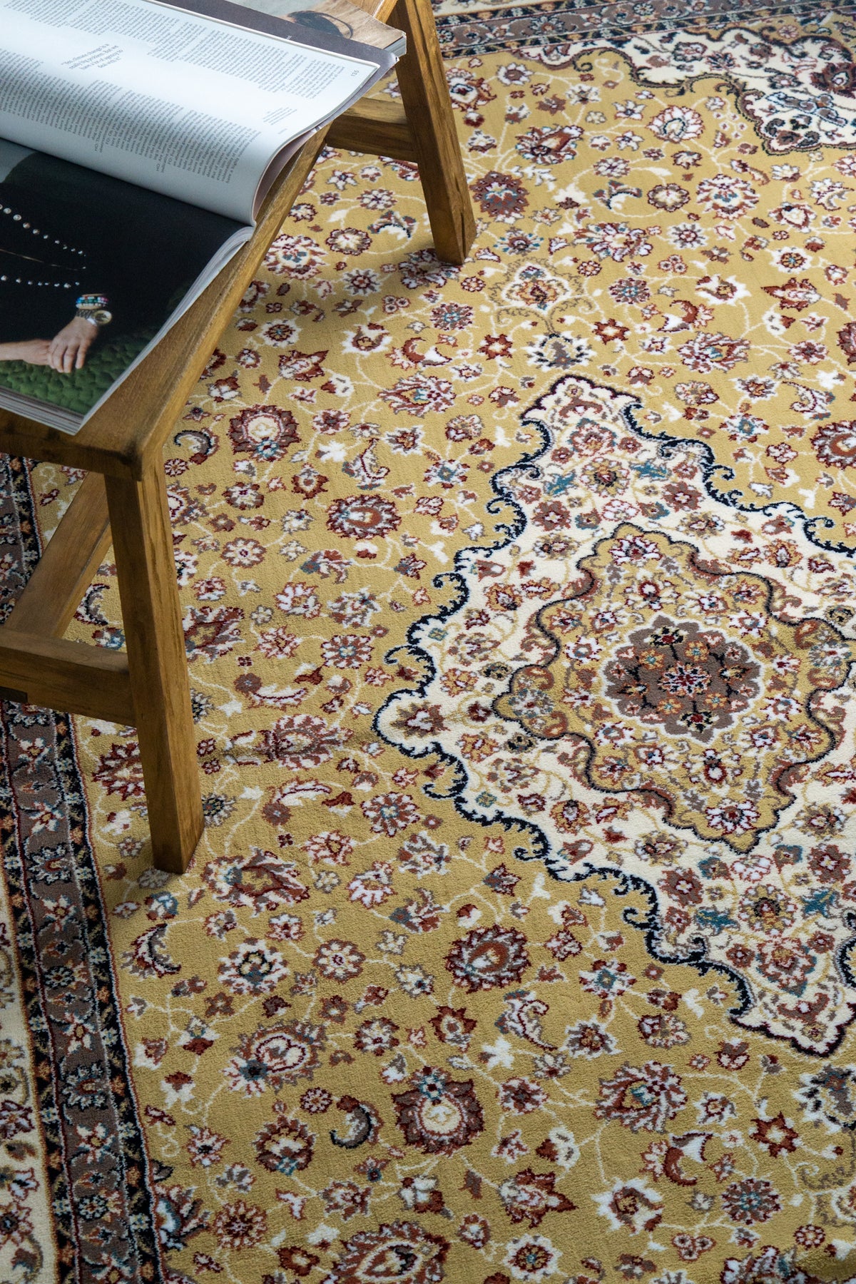 Traditional Persian rug with gold center, cream border and ornate floral medallion pattern