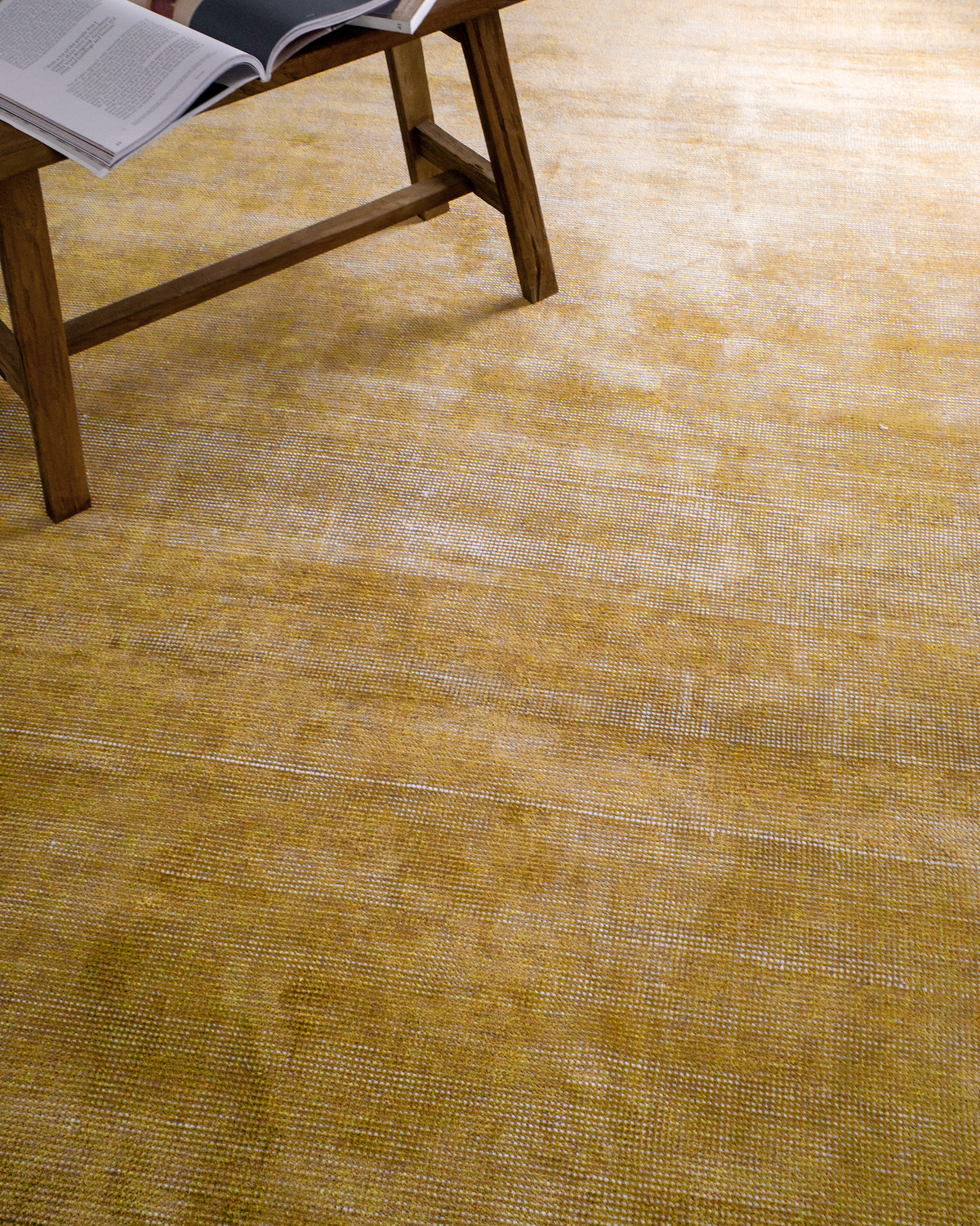 Golden yellow velvet rug with subtle grid texture pattern and worn vintage finish