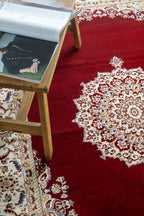 Burgundy traditional rug with ornate gold and cream floral medallion pattern