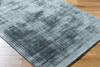 Modern distressed blue-grey rug with abstract worn texture pattern