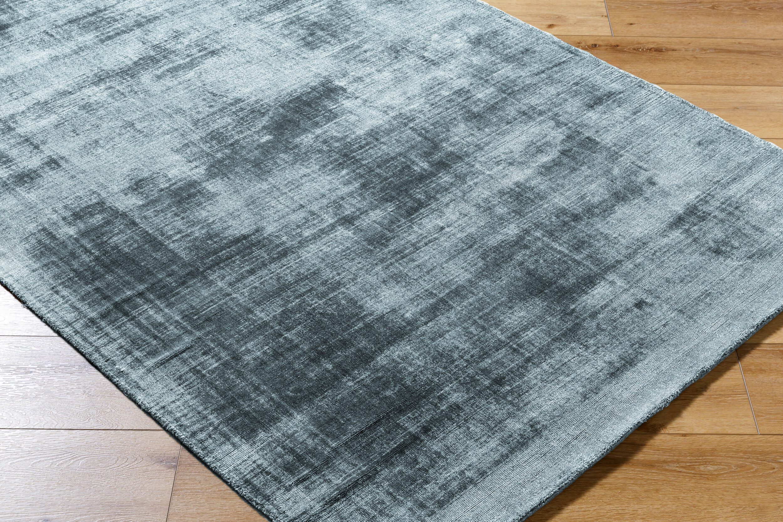 Modern distressed blue-grey rug with abstract worn texture pattern