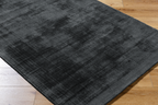Dark grey distressed wool rug with subtle texture and mottled finish