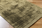 Distressed gold and charcoal textured area rug with abstract worn finish