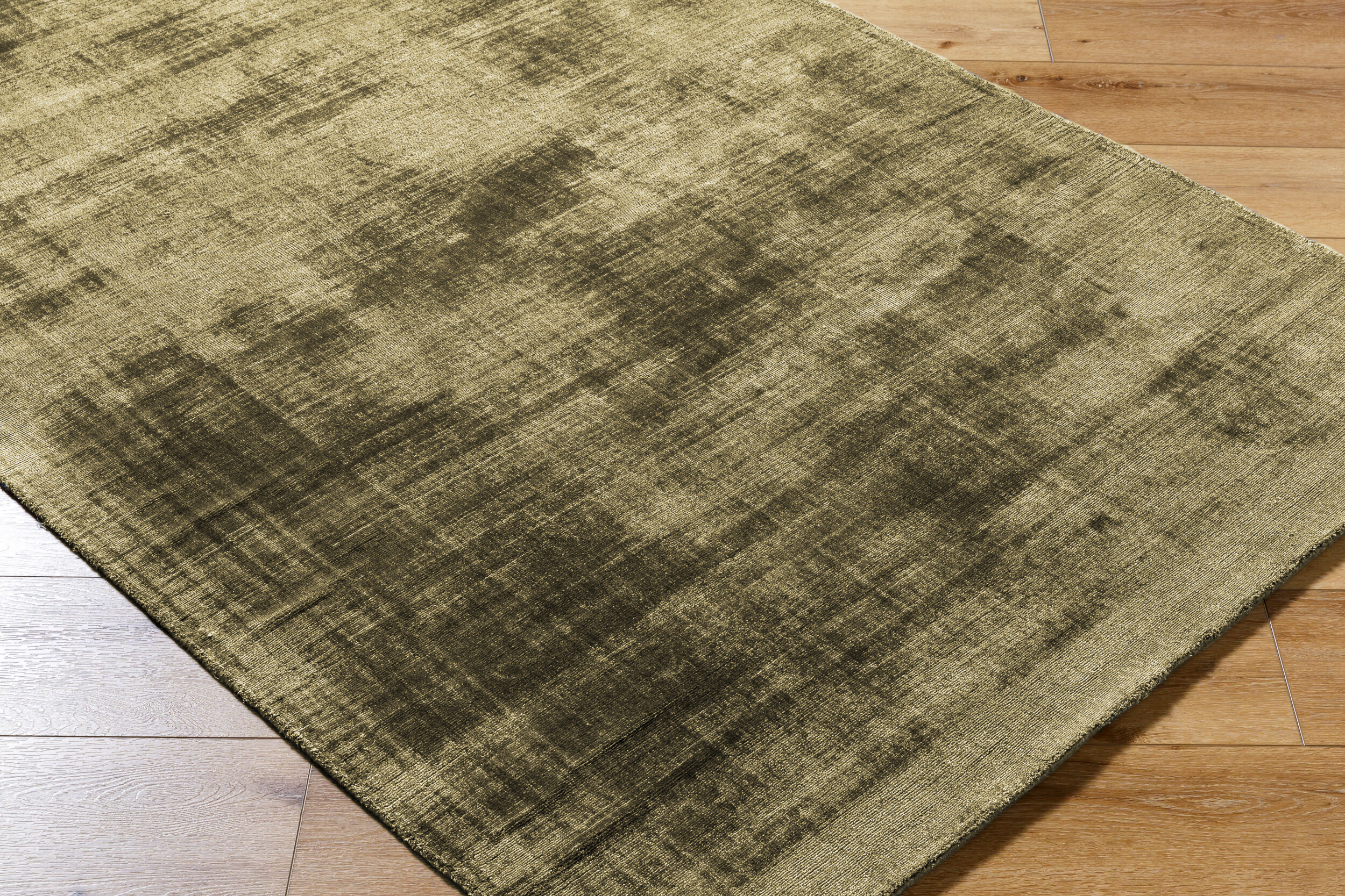 Distressed gold and charcoal textured area rug with abstract worn finish