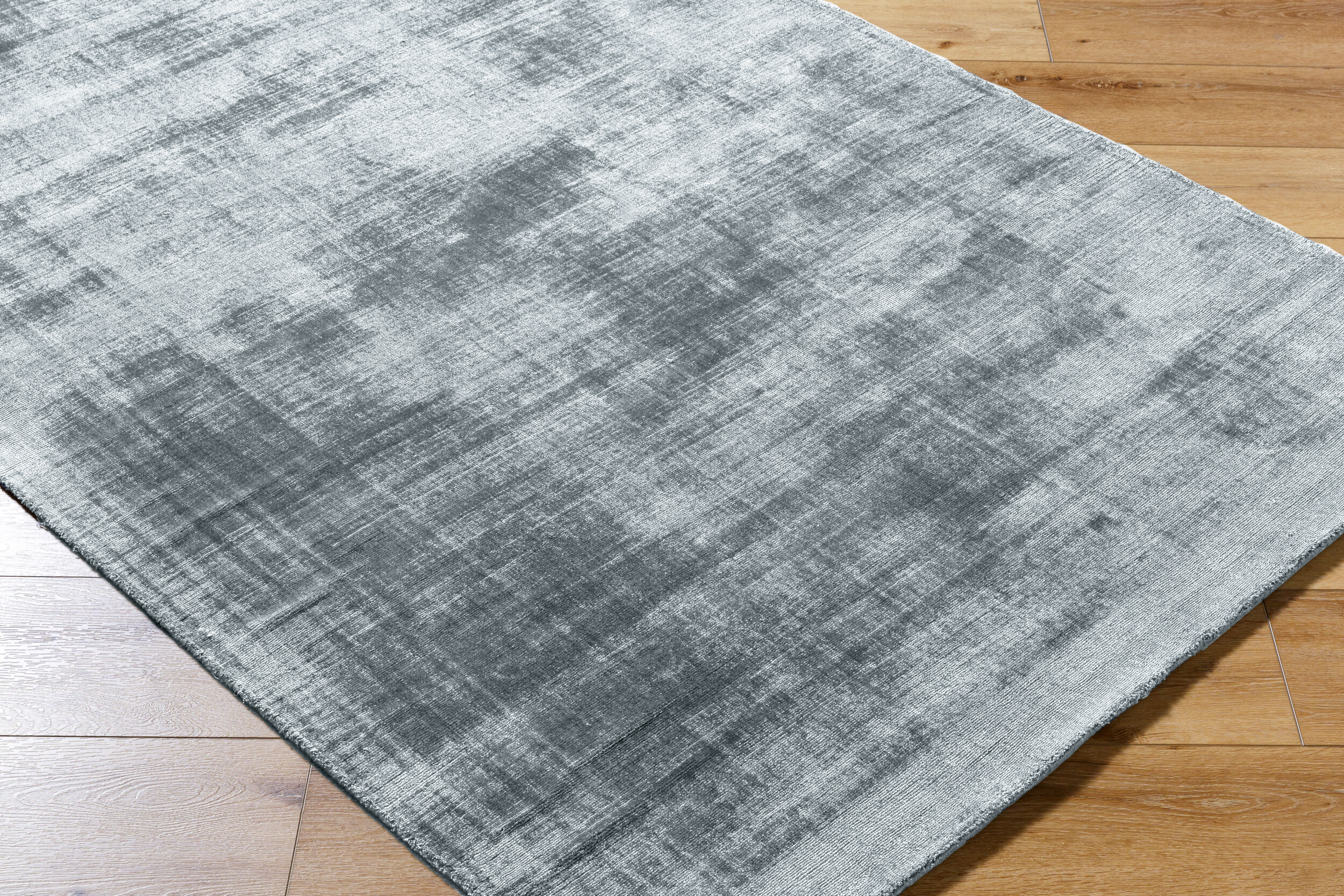 Light blue textured area rug with subtle grey distressed pattern and worn finish