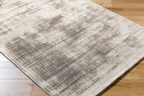 Cream and grey distressed textured rug with mottled abstract pattern