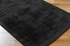 Dark charcoal grey distressed wool rug with subtle texture pattern