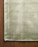 Sage green textured velvet rug with subtle worn vintage distressing throughout