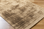 Distressed tan and brown textured area rug with worn vintage appearance