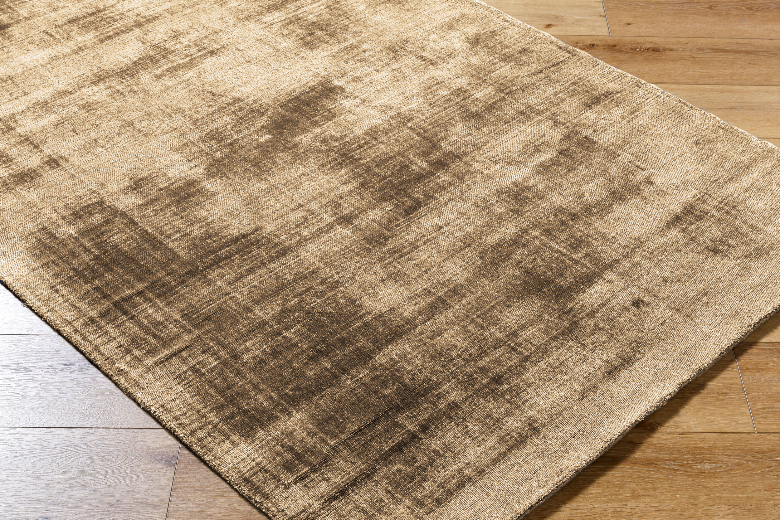 Distressed tan and brown textured area rug with worn vintage appearance