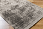 Modern distressed gray area rug with abstract textured pattern and neutral tone