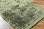 Sage green distressed texture area rug with mottled vintage appearance