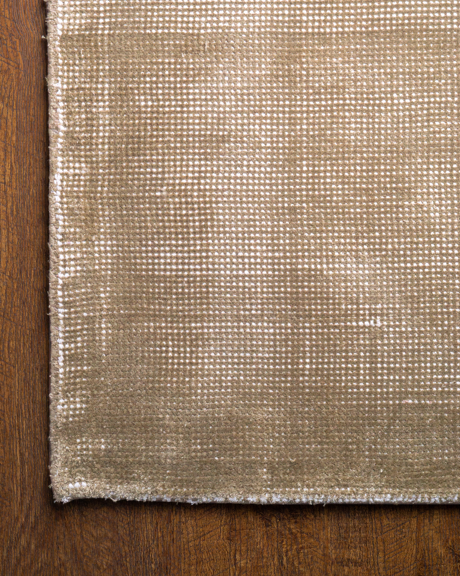 Beige textured rug with subtle horizontal striations and soft woven finish
