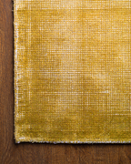 Golden yellow velvet rug with subtle grid texture pattern and worn vintage finish