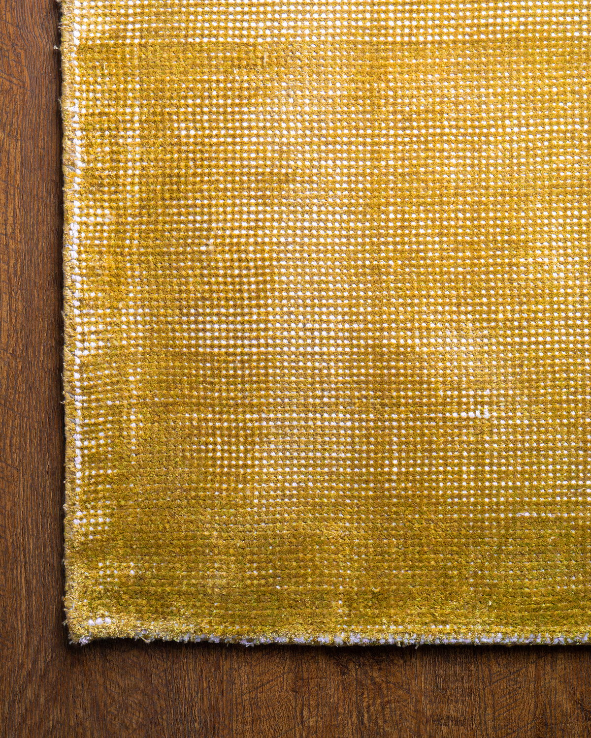 Golden yellow velvet rug with subtle grid texture pattern and worn vintage finish
