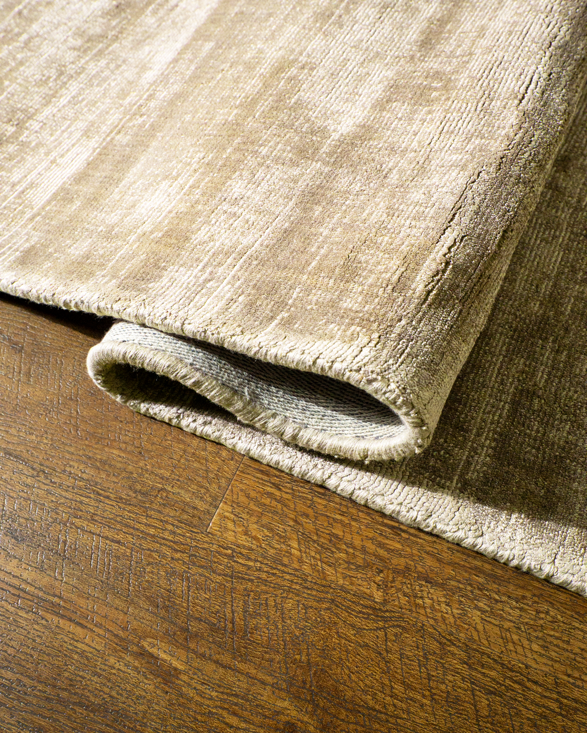 Amara viscose hand-loomed area rug in Shell Beige, curled edge detail