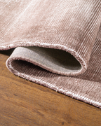 Soft taupe velvet rug with subtle texture and minimalist design