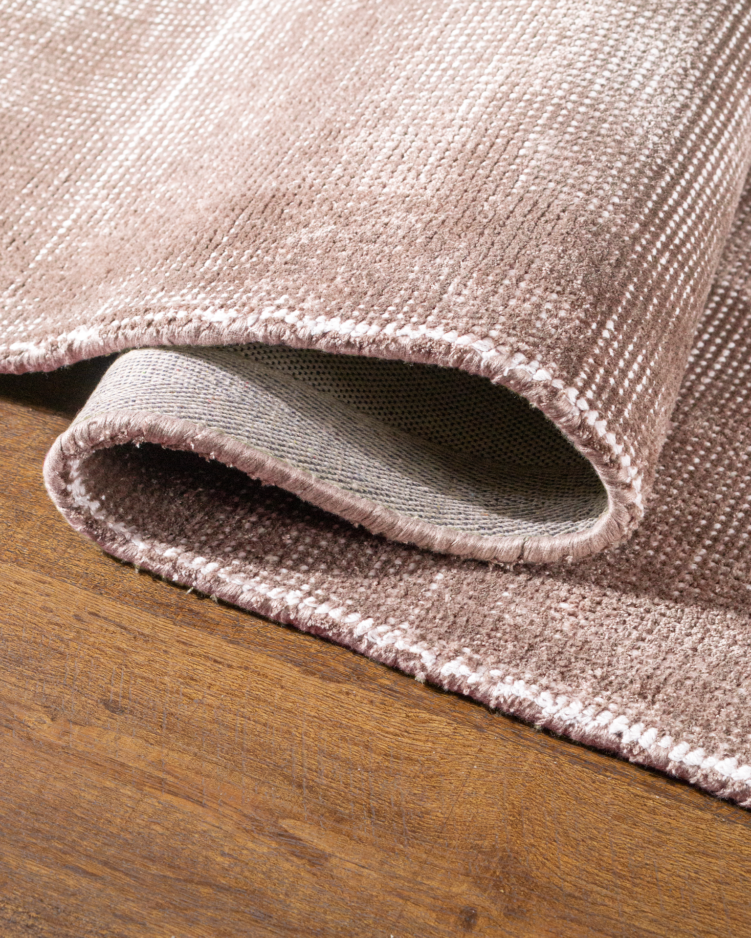 Soft taupe velvet rug with subtle texture and minimalist design