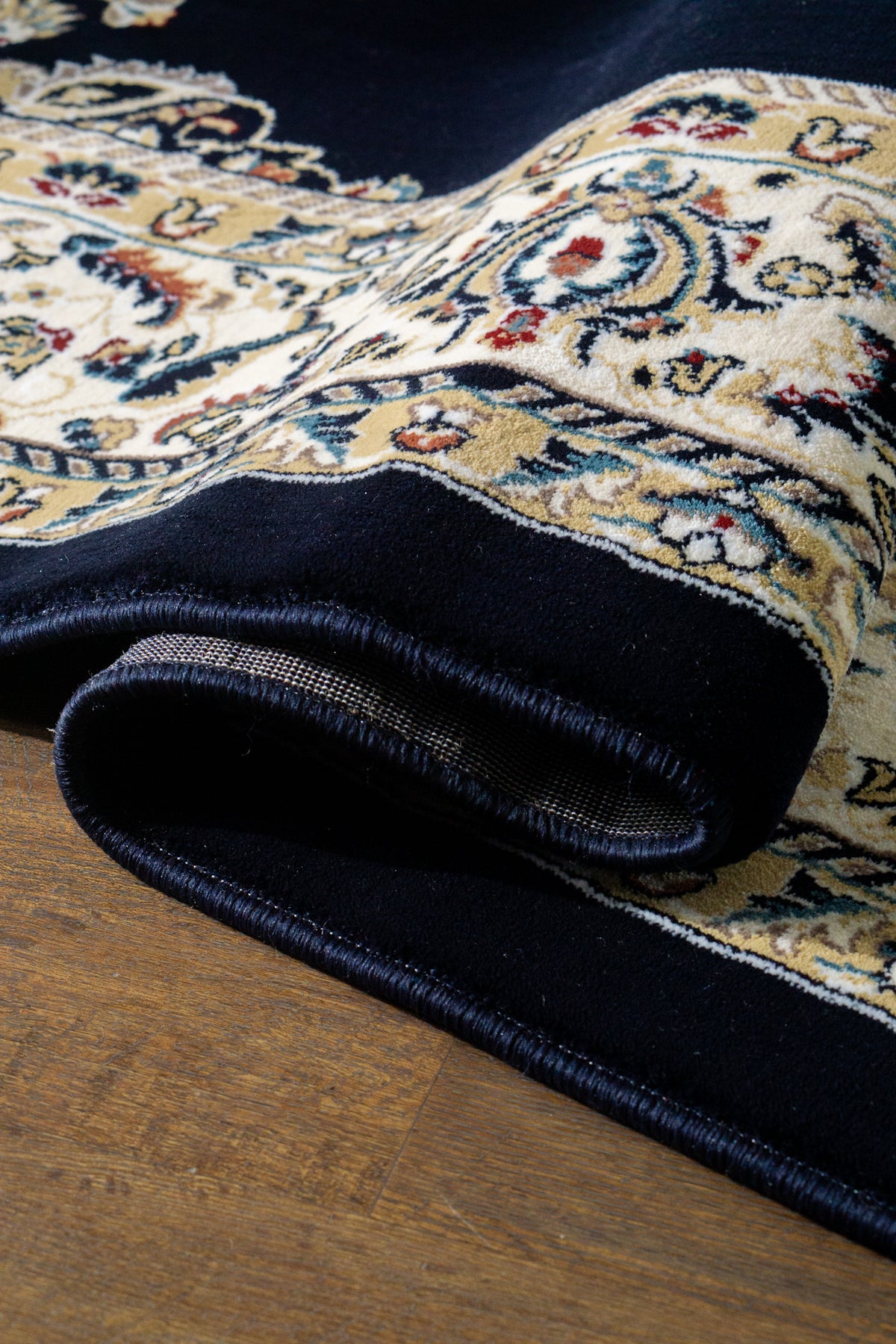 Black and gold traditional Persian style rug with ornate medallion pattern