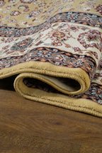 Traditional Persian rug with gold center, cream border and ornate floral medallion pattern