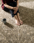 Taupe geometric damask patterned rug with textured woven appearance