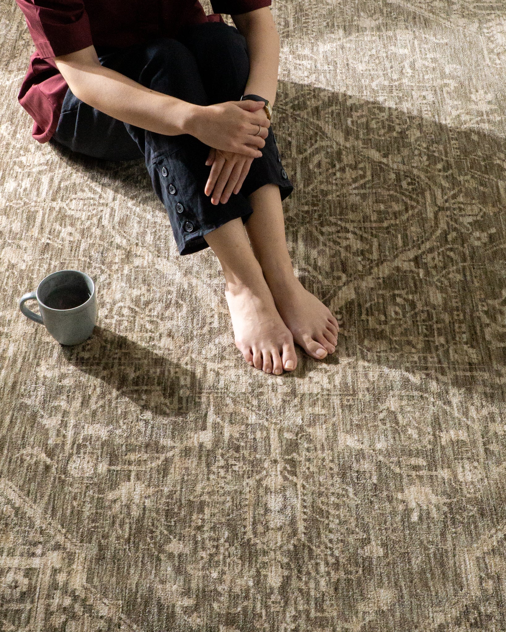 Taupe geometric damask patterned rug with textured woven appearance