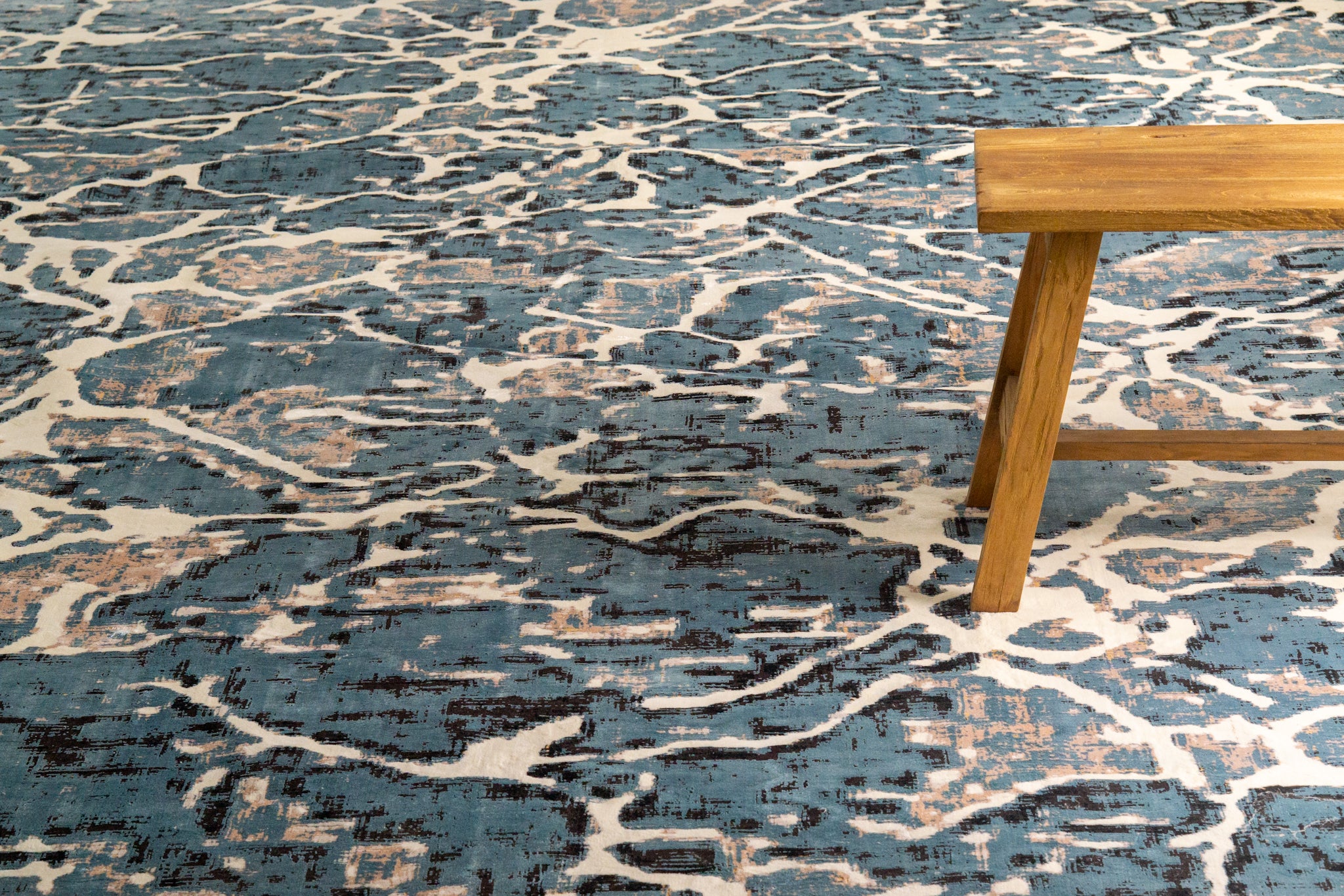 Vintage-inspired blue and cream crackle pattern area rug with distressed texture