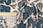 Vintage-inspired blue and cream crackle pattern area rug with distressed texture