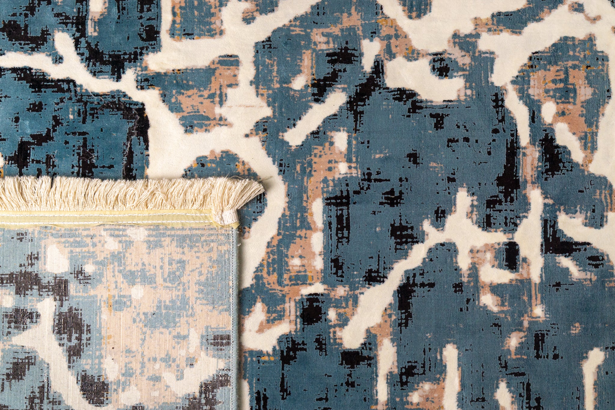 Vintage-inspired blue and cream crackle pattern area rug with distressed texture