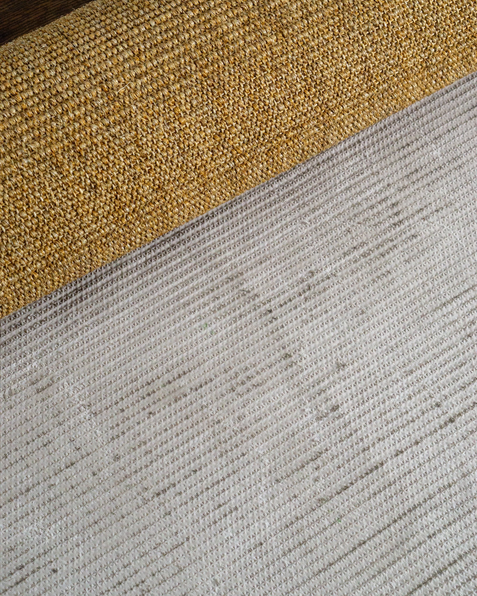Natural woven jute rug with tight ribbed texture in golden tan color