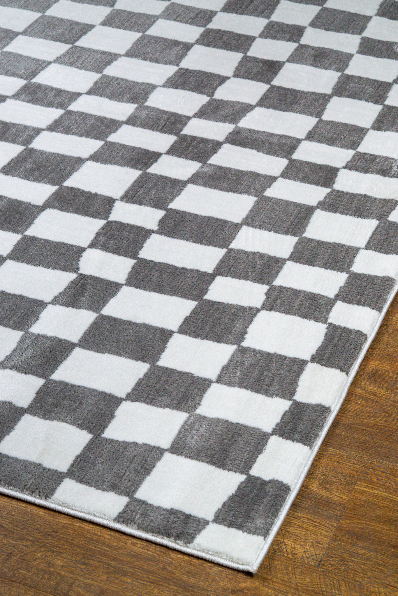Charcoal and cream checkered wool rug with textured woven pattern