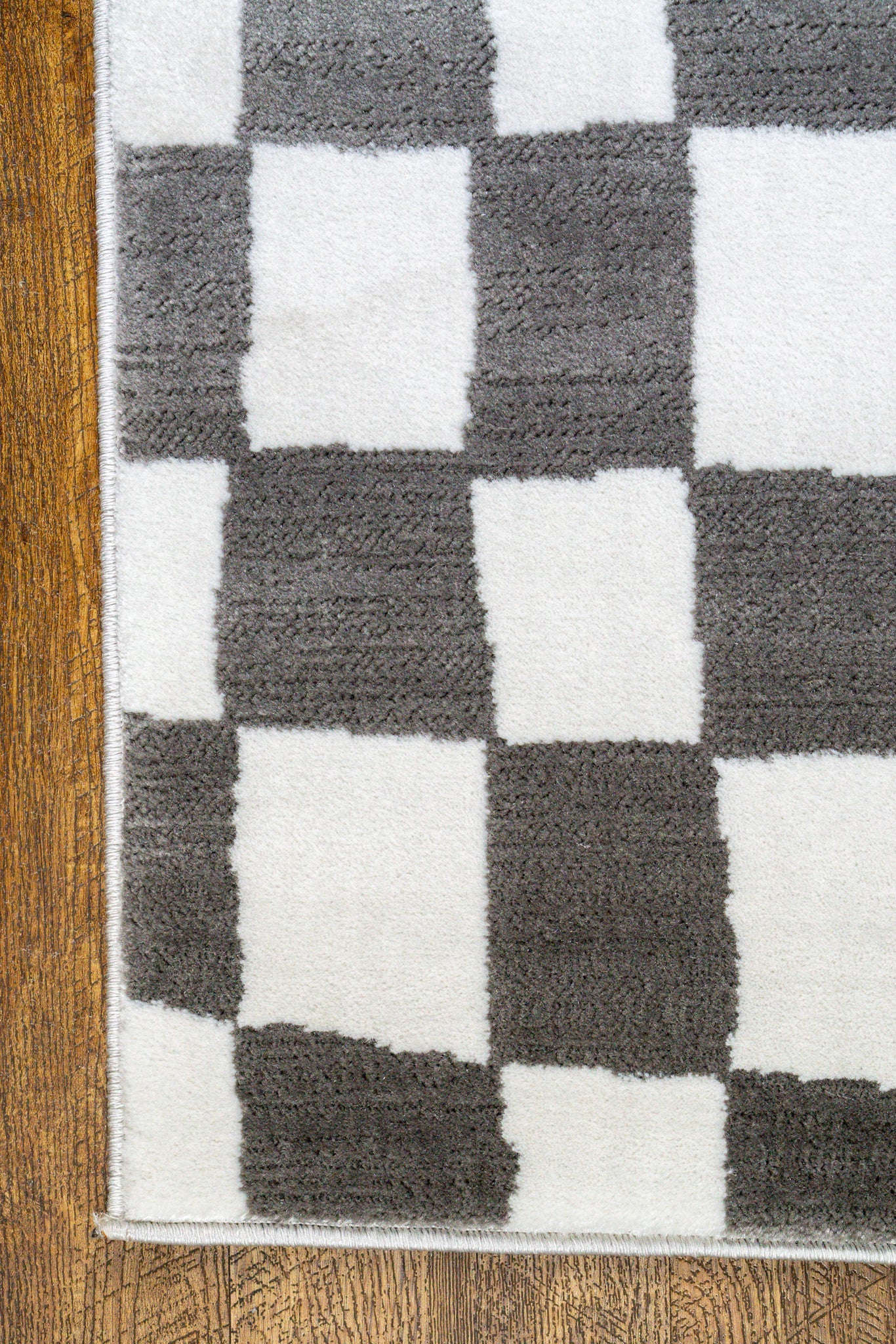 Charcoal and cream checkered wool rug with textured woven pattern