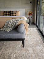 Distressed beige and taupe abstract rug with weathered texture design