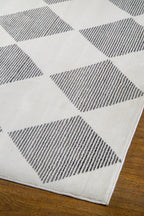 Modern geometric diamond pattern rug in black and white with textured weave