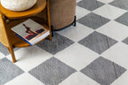 Modern geometric diamond pattern rug in black and white with textured weave