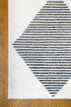 Modern geometric diamond pattern rug in black and white with textured weave