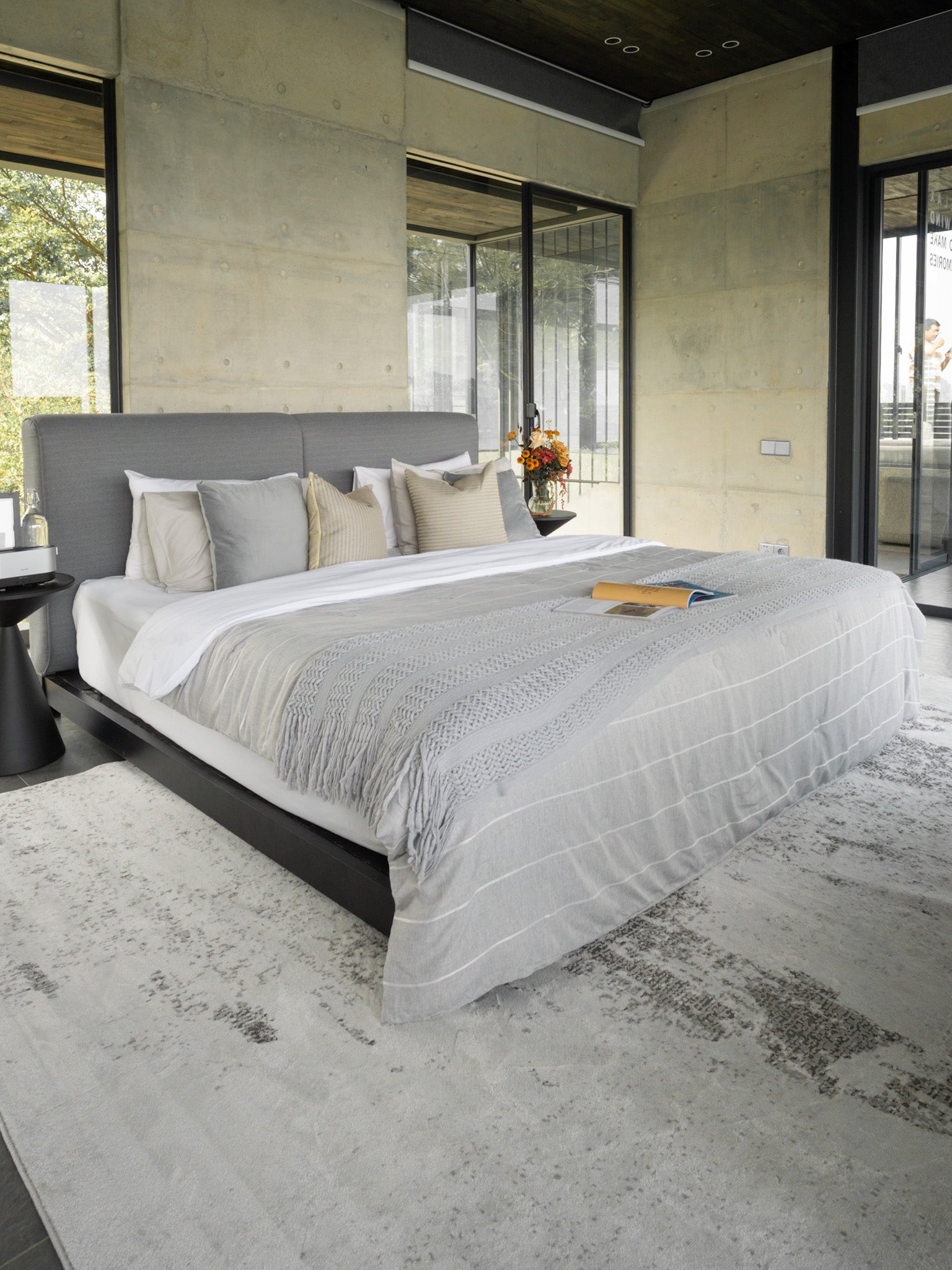 Distressed grey and white rug with abstract speckled texture and worn finish