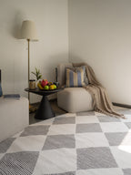Modern geometric diamond pattern rug in black and white with textured weave