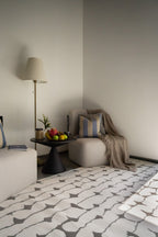 Modern geometric rug with black vertical lines and diamond shapes on white