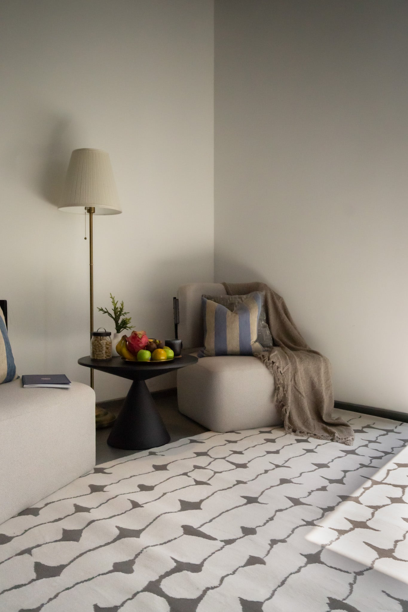 Modern geometric rug with black vertical lines and diamond shapes on white