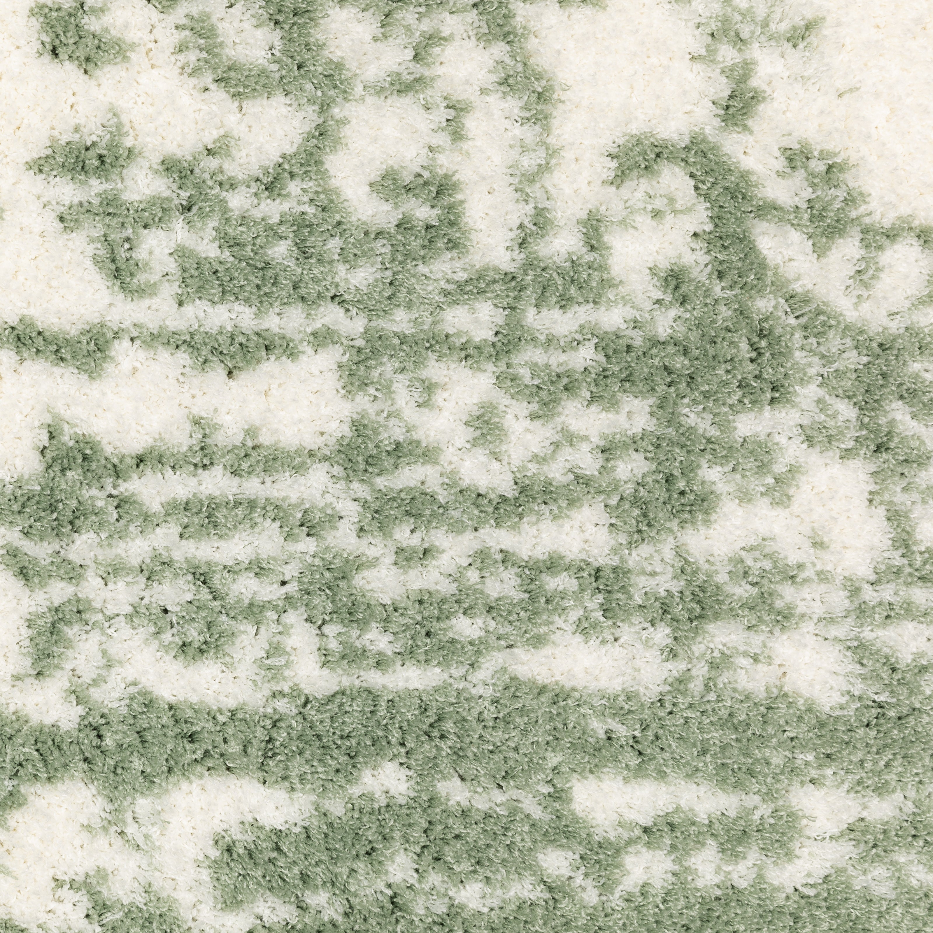 Green and white distressed textured area rug with abstract marbled pattern
