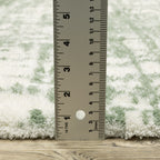 Green and white distressed textured area rug with abstract marbled pattern
