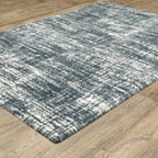 Modern teal and white textured area rug with abstract distressed pattern