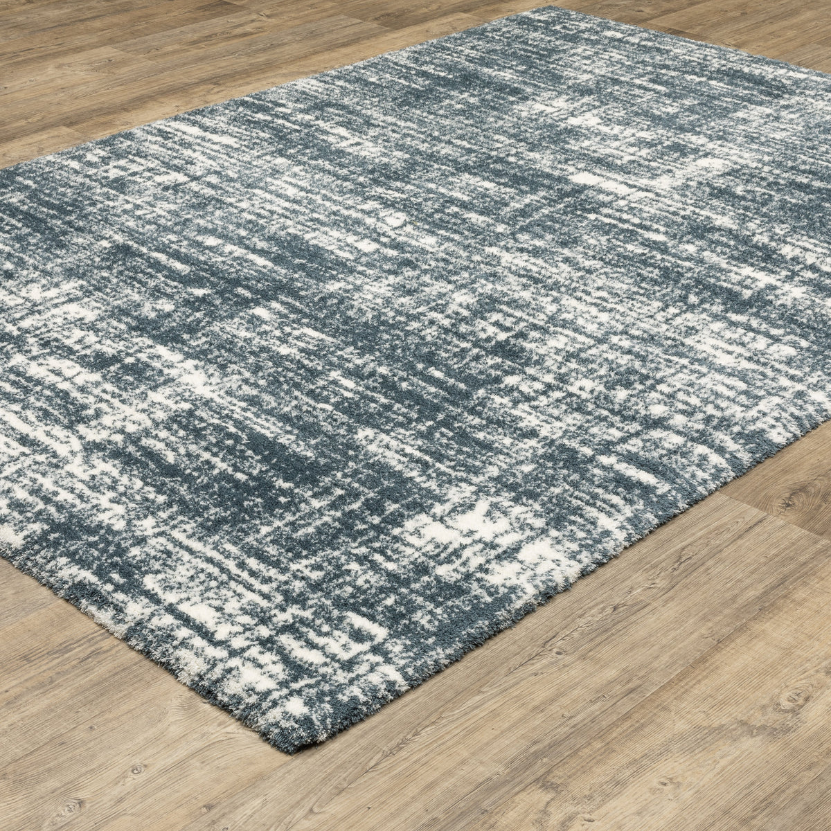 Modern teal and white textured area rug with abstract distressed pattern