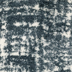 Modern teal and white textured area rug with abstract distressed pattern